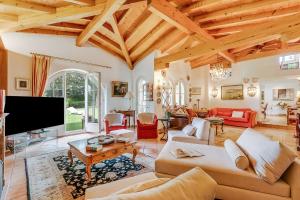 a living room filled with furniture and a flat screen tv at Villa Tre Pini Garden Escape in Lugano