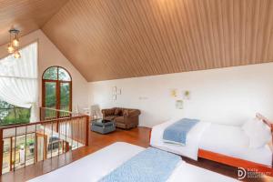 a large bedroom with two beds and a staircase at Umacabana 2 in Diyeng +46 photos