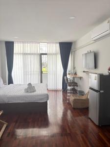 a bedroom with a bed and a refrigerator in it at S Hostel sukhumvit48 Near Phrakanong BTS 2001 in Bangkok