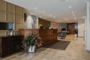 a lobby with a reception desk in a building at Home Hotel Bastion in Oslo
