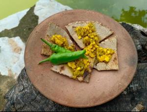 a plate of food with bread and a green vegetable on it at Maanjoofarms Pilani in Pilani +15 photos