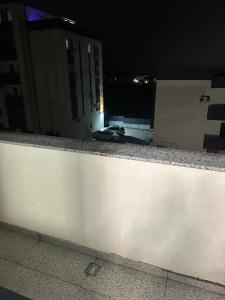 a white wall with a car on top of it at night at Apartament Magnolia Panoramic in Craiova