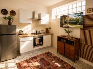 a kitchen with a refrigerator and a sink at Iris Peaceful Apartment near Lake Como and Lugano in Lanzo dʼIntelvi +20 photos