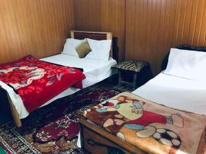 a hotel room with two beds and avertisement at Rama lake view Hotel in Astor