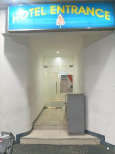 a hotel entrance with a sign on the wall at Nice Hotel in Manila