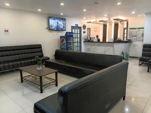 a waiting room with a couch and a table at Nice Hotel in Manila