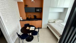 a small room with a table and chairs and a bed at Apartmán Vita Smart in Trenčín +11 photos