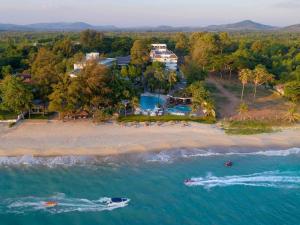 an aerial view of a beach with a boat in the water at Novotel Rayong Rim Pae Resort in Klaeng