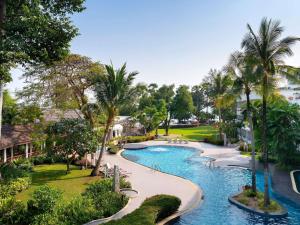 an aerial view of a resort pool with palm trees at Novotel Rayong Rim Pae Resort in Klaeng