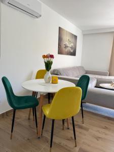 a dining room with a table and four chairs at Magic Home Cetinje in Cetinje