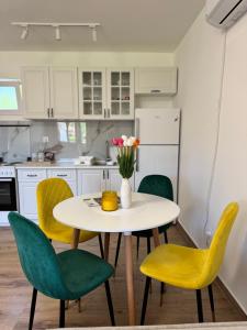 a kitchen with a table and chairs with a vase of flowers at Magic Home Cetinje in Cetinje