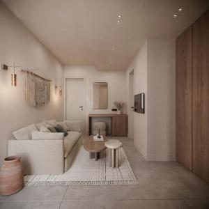 a living room with a couch and a table at Breaq Santorini - Margarita Hotel in Firostefani +3 photos