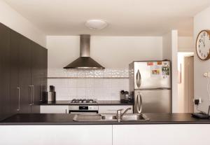a kitchen with a stainless steel refrigerator and a sink at Moyne Views 2 in Port Fairy