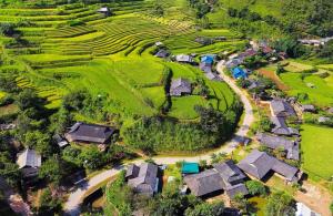 an aerial view of a village with houses and a road at Nhà Gỗ Cạnh Suối in Bản Det