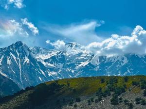 a view of a mountain range with snow at Rama lake view Hotel in Astor
