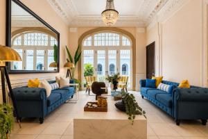 a living room with blue couches and a table at Hotel Magnolia Boutique in Panama City
