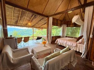 a bedroom with two beds and a couch and chairs at Wanna’s house in Ban Huai Khai +20 photos