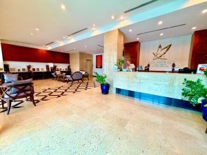 a lobby of a hotel with a bar and chairs at Sabaidee@Lao Hotel Vientiane in Vientiane