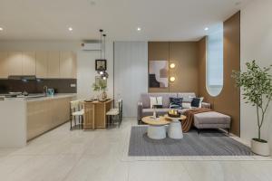 a living room and kitchen with a couch and a table at Veone Hotel Kuala Lumpur in Kuala Lumpur
