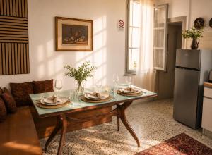 a living room with a table and a refrigerator at Iris Peaceful Apartment near Lake Como and Lugano in Lanzo dʼIntelvi
