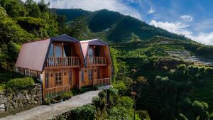 a house on the side of a mountain at Emerald Cabin House in Kejajar