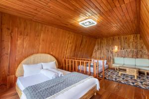 a bedroom with a bed in a wooden room at Emerald Cabin House in Kejajar