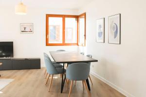 a dining room with a table and chairs at Large apartment with balcony - Stade de France in Saint-Denis +25 photos