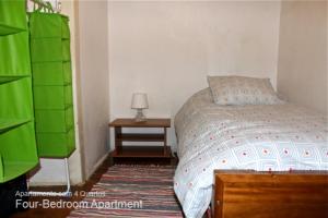 a bedroom with a bed and a night stand with a lamp at Akicity Bairro Alto Night in Lisbon