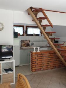 a living room with a staircase and a kitchen at Ferienhaus mit Pool am See in Malchow +9 photos