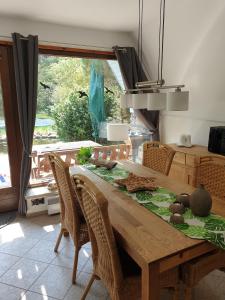 a dining room table with chairs and a large window at Ferienhaus mit Pool am See in Malchow