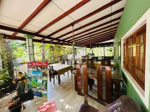 a dining room with a table and chairs at Rest Full Homestay in Ella