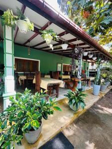a patio with tables and potted plants in a restaurant at Rest Full Homestay in Ella