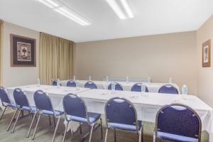 a conference room with a long table and blue chairs at Days Inn by Wyndham Dublin GA in Dublin