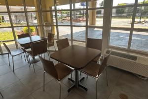 a table and chairs in a room with windows at Days Inn by Wyndham Atlanta Stone Mountain in Stone Mountain