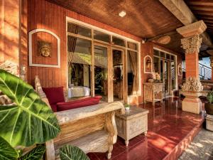 a living room with a couch on a house at Purnama House Ubud in Ubud
