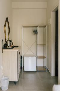 a room with a white refrigerator and a shelf at Karamelaki in Pythagoreio +41 photos