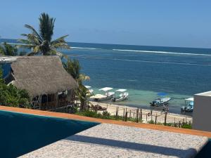 a view of a beach with boats in the water at Casa Velero Puerto Morelos in Puerto Morelos +43 photos