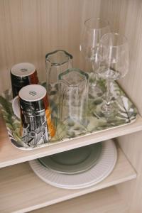 a shelf with wine glasses and plates on it at Karamelaki in Pythagoreio
