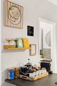a kitchen counter with a stove with pots and pans at OPTUS Stadium 2BR CBD Apartment with FREE Parking in Perth