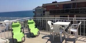 a balcony with a table and chairs and the ocean at Hotel Zora by TM in Ravda