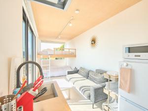 a small living room with a couch and a bed at Awaji Dog Hill in Kusumoto