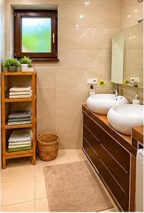 a bathroom with two sinks and a mirror at Chalet-Širava in Vinné