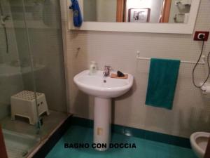 a bathroom with a sink and a glass shower at casaNARDIELLO in Capua