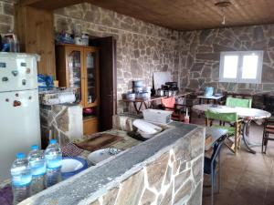 a kitchen with a counter with bottles of water at Bee happy in Agioi Apostoli