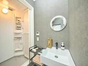 a bathroom with a white sink and a mirror at Awaji Dog Hill in Kusumoto +52 photos