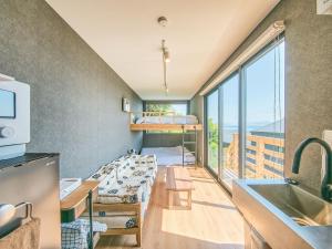 a small room with a bunk bed and a kitchen at Awaji Dog Hill in Kusumoto