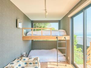 a bunk bed in a room with a window at Awaji Dog Hill in Kusumoto