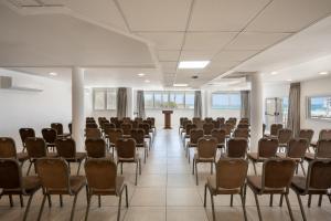an empty room with chairs and a podium in it at Naveh Tamar - Mehadrin Kosher suitable for Ultra-Orthodox guests in Acre +28 photos
