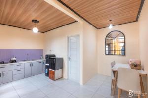 a large kitchen with a table and a kitchen with a tableablish at Umacabana 2 in Diyeng