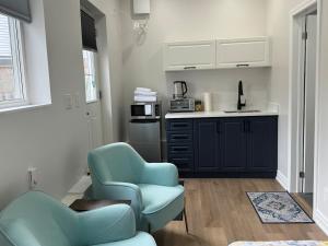 a kitchen with two blue chairs in a room at Home away from home! in Pickering